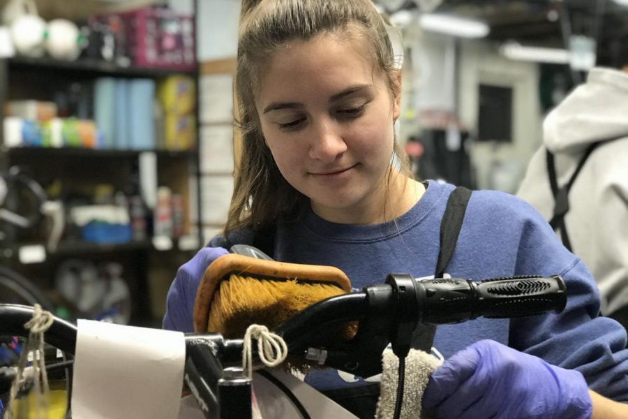Caitlyn Sigman cleans a bike. In order for a bike to be properly cleaned, cleaners have to follow an extensive list to help restore the bike to a great condition to be donated to charity,