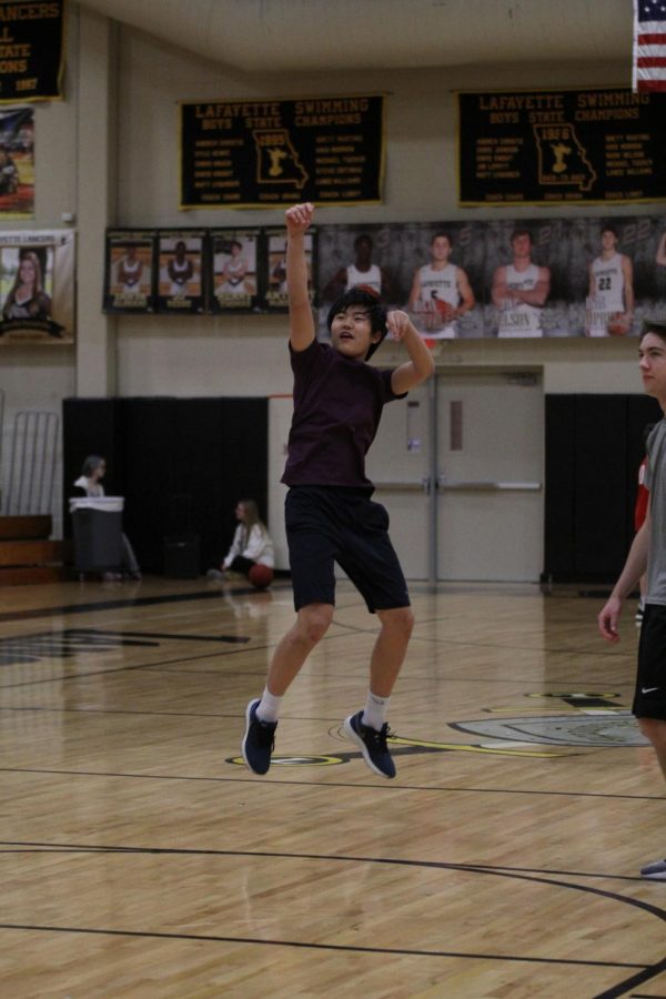 While warming up with his team, Golden Oreo, senior Kevin Peng takes a shot. Despite there originally being high school girls and boys competitive, high school co-ed recreational, middle school boys and girls and adult leagues, there were only high school and middle school boys teams who signed up for the tournament. 