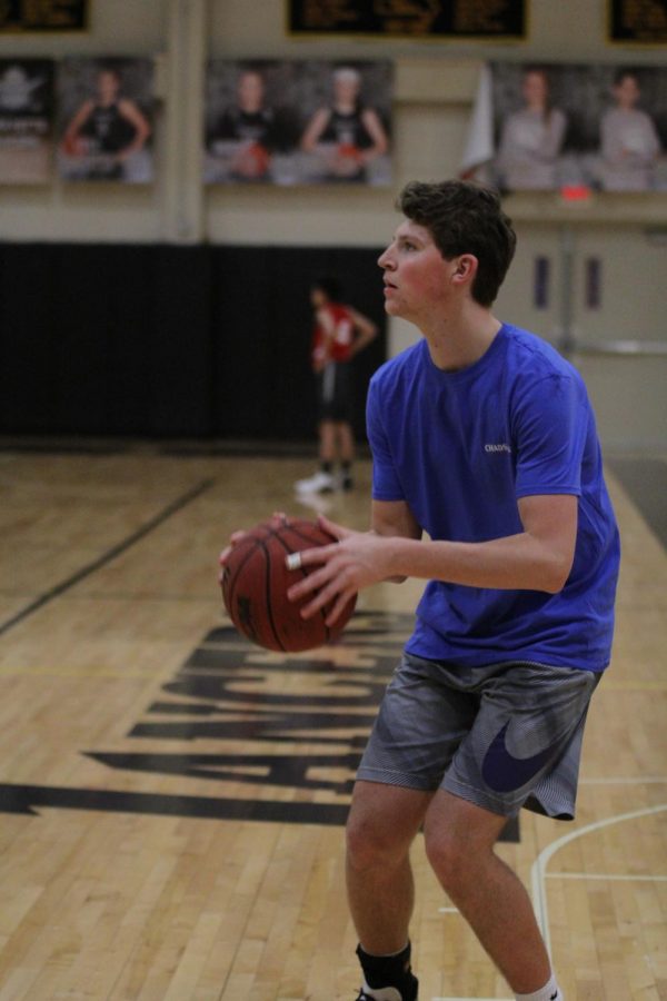 Playing in a game with his team, FTC, senior Michael Olsen takes a three point shot. Olsen led FTC to the tournaments championship game which they won 24-19, earning themselves gift cards to Imos Pizza and The Shack. 