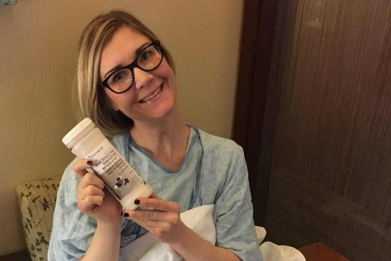 In the hospital, Danna Stone holds a bottle of contrast she has to drink before getting scanned for cancer. Stone has been cancer-free since 2017.