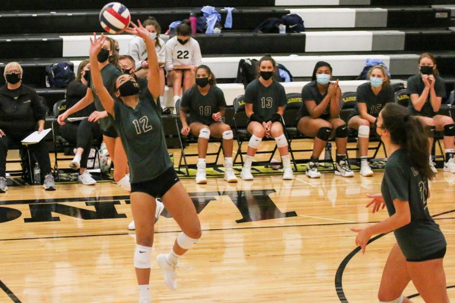 Senior Jenny Nguyen jumps up to set the ball in the Lancers game against Borgia on Oct. 13. This was the only game the team has lost this season, but they have the possibility to play them again should they make it deep into playoffs.