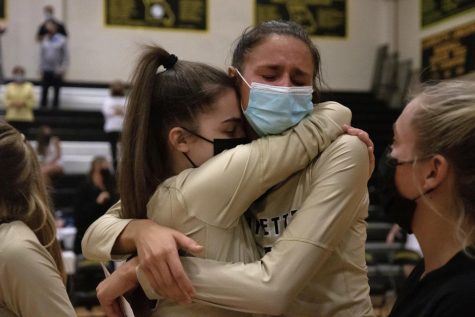 At the end of her final home game for the Lancers, senior Morgan Isenberg hugs a teammate. The Lancers beat Seckman in four sets.
