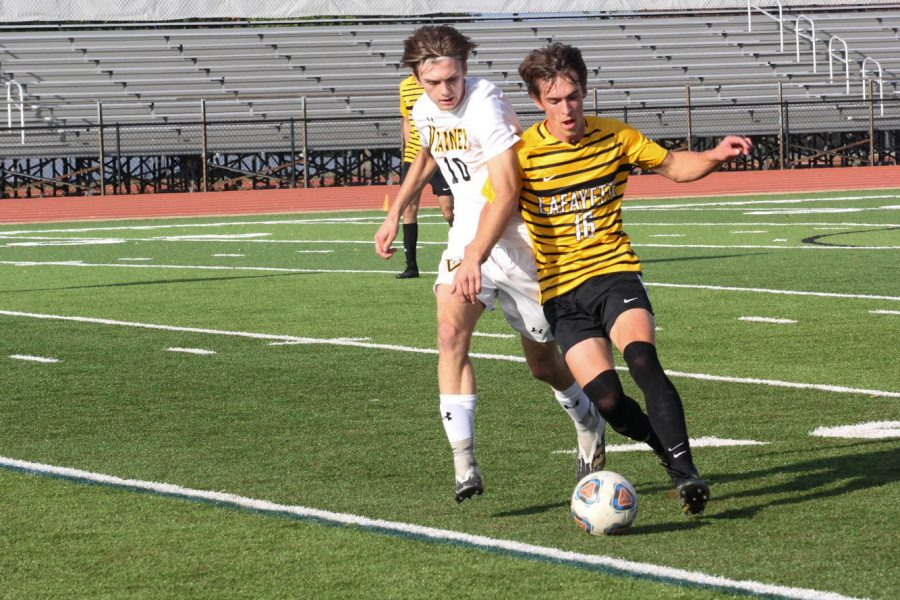 In a game against Vianney on Oct. 2, senior Luc Fladda dribbles around an opponent to get the ball upfield. The Lancers lost in their match against Vianney 3-1, with the only goal being scored by senior Mitchell Grant.