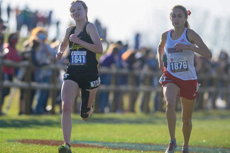 Sophomore Elissa Barnard runs alongside her Parkway West competitor in the Missouri State High School Activities Association (MSHSAA) Cross Country Competition. Barnard placed ninth in the competition, running the event with a time of 18:43.60. That time helped the Lady Lancers become State Champs for the third time in their history.