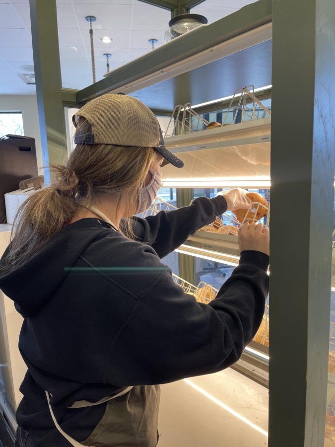 Junior Marissa Trottier restocks bagels during her morning shift at St. Louis Bread Company in the Chesterfield Commons.  