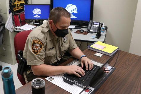 Lafayette High Schools Resource Officer Chad Deakin works at his desk on Dec. 12 at Lafayette. SROs work hard to build positive relationships with all students while maintaining a safe environment for everyone, Deakin said.