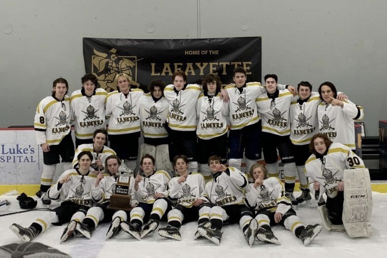 The Lancers pose after winning the Silver Skate game against Marquette on Dec. 31. It was their first win in the annual event against the Mustangs in six years.