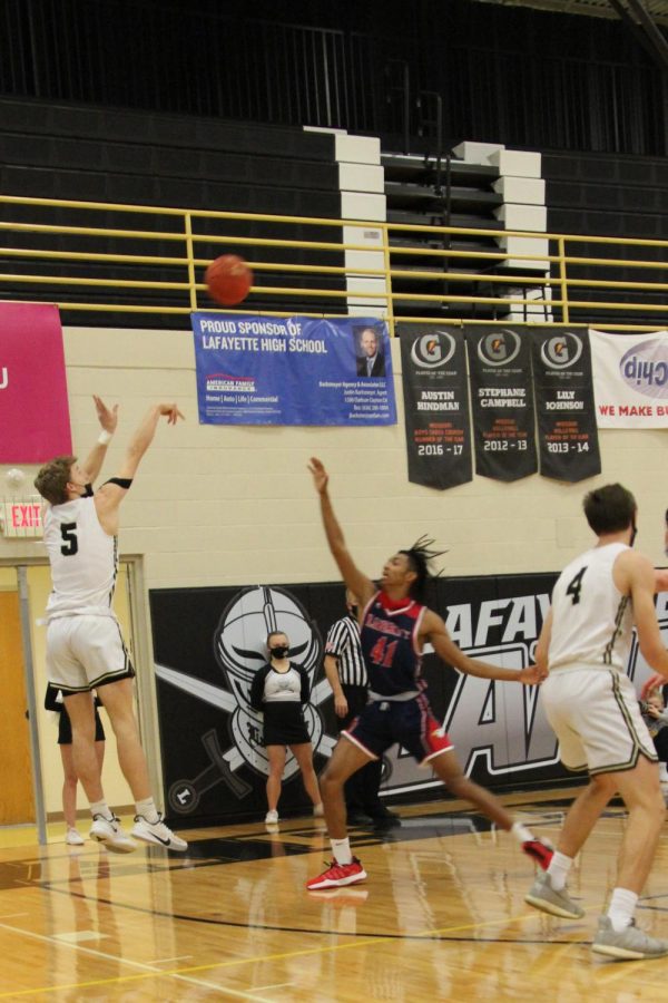 From just outside the three-point line, junior Matt Jones jumps for the shot. In their senior night on Jan. 14, the Lancers beat Liberty by a final score of 59-51.