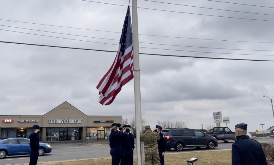 ROTC sponsors Lt. Col. Jim Smith, Mst. Sgt. Matt Zahradka, and their students raise a new flag for the Mobile On The Run gas located at 14807 Manchester Road in Ballwin.