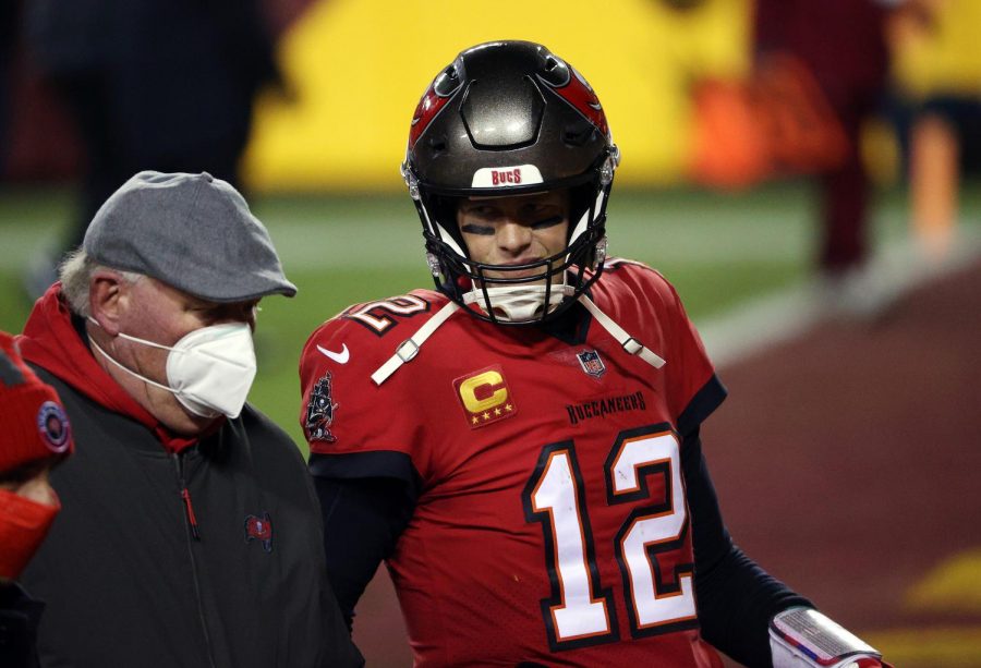 Tampa Bay Buccaneers quarterback Tom Brady (12) walks off the field alongside head coach Bruce Arians after a 31-23 victory against the Washington Football Team in the NFC Wild Card Playoffs at FedExField in Landover, Maryland, on Saturday, Jan. 9, 2021.