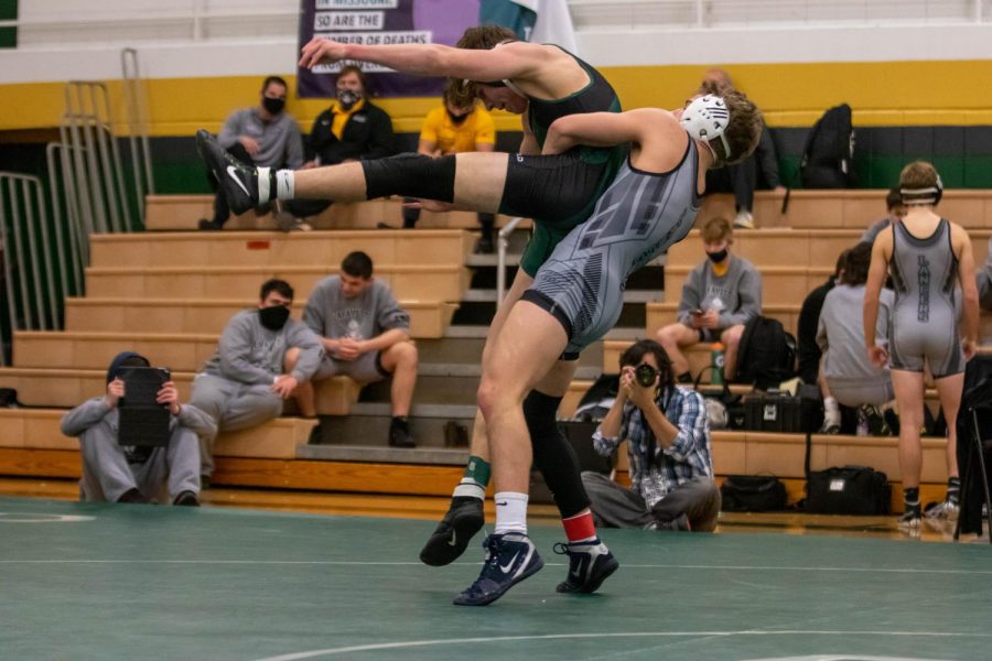 Junior Drew Doehring flips his opponent through the air in a match at the Quad they participated in on New Years Eve. They won the Quad, and now their record sits at 31-1 as they head into Districts.
