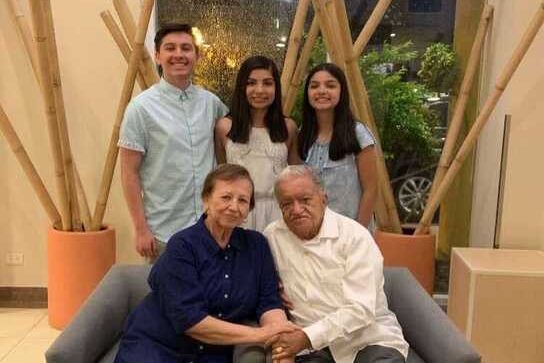 Kate Vera and her siblings pose with their grandparents while visiting them before the pandemic.