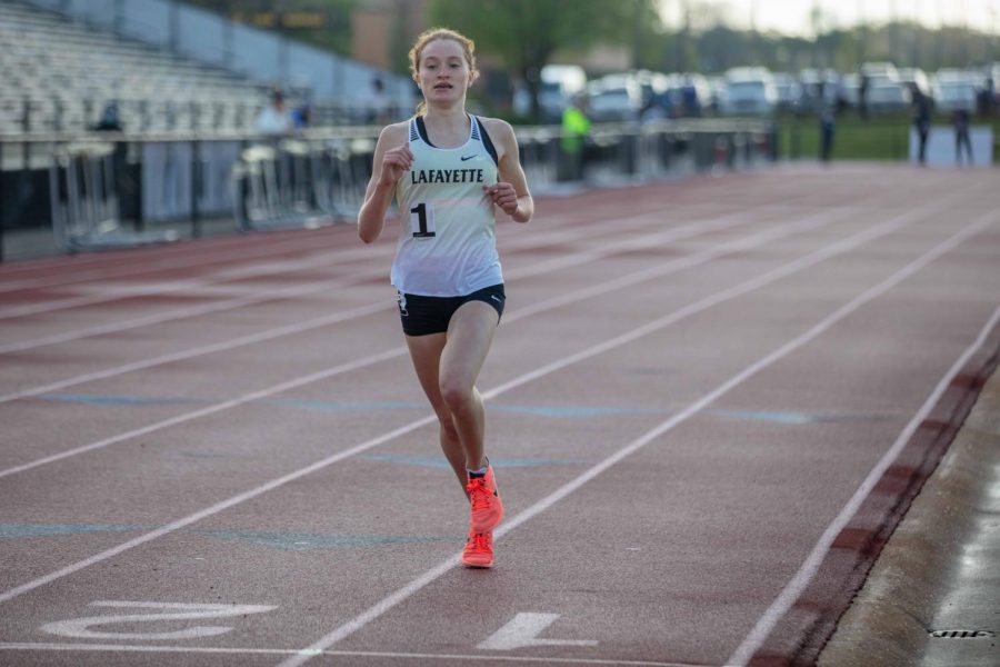With nobody else in sight, sophomore Grace Tyson runs across the finish line in the two-mile run. Her time was 10:51 seconds, with the next best finisher being sophomore Elissa Barnard with a time of 11:21.