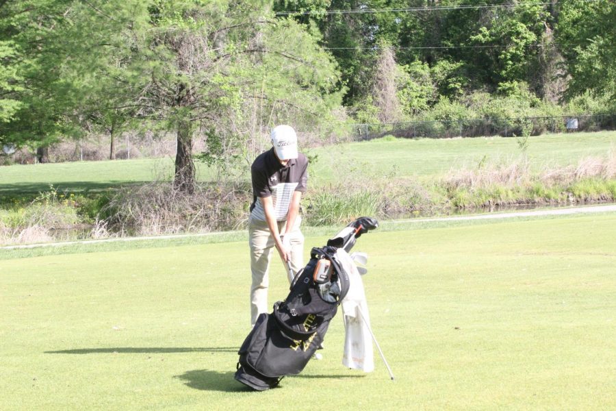 Lining up his shot, junior Kyle Rinkenberger takes a few moments as he gets ready for his swing. The golf team placed second in the Yellow Pool Suburban Conference Tournament on May 5. 