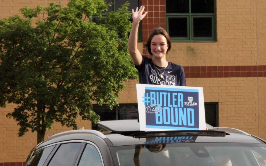 With her sign proudly announcing her college choice, senior Rachel Brown waves at Lafayette staff members in the parking lot during the Senior Salute Parade on May 24. Though not part of the official Senior Week events, the parade of seniors was another special event for the Class of 2021.