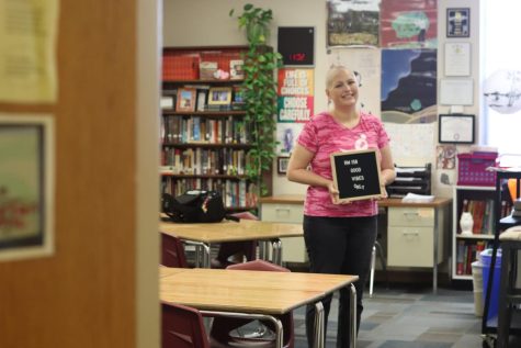 Language arts teacher Jenny Ingram stands in her classroom holding her Good Vibes Only sign. In June 2021 Ingram learned that her Breast Cancer resurfaced as Stage Four. She has since made an effort to maintain a positive perspective.