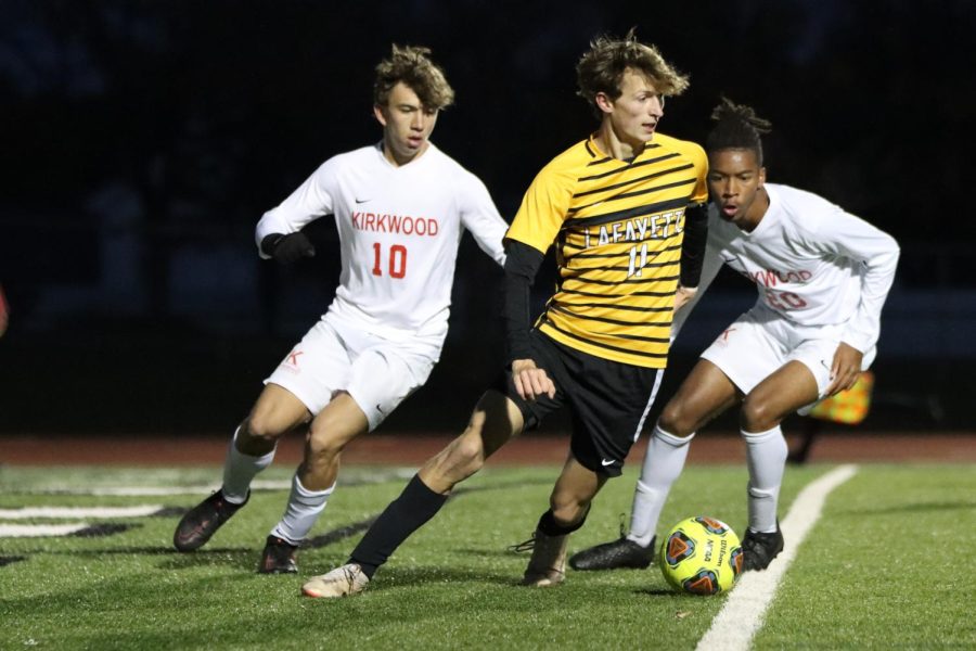 Senior captain Kaden Karr dribbles the ball to keep it away from Kirkwood on Nov. 1. The team won the game 3-1, which was their last win of the season.