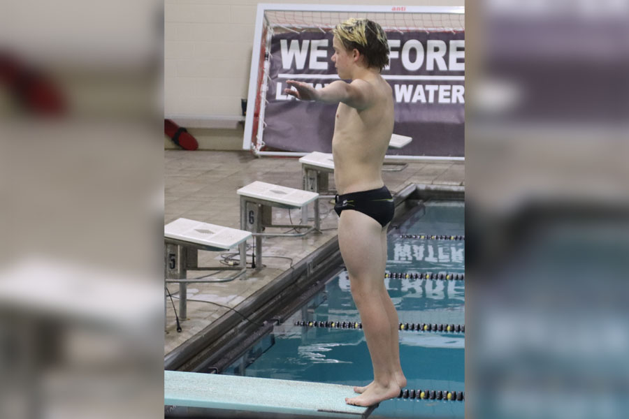 Freshman Jackson Tenny prepares to dive at a meet against Marquette on Oct. 12. The team placed 14th overall in the Missouri Class 2 State Championships. 