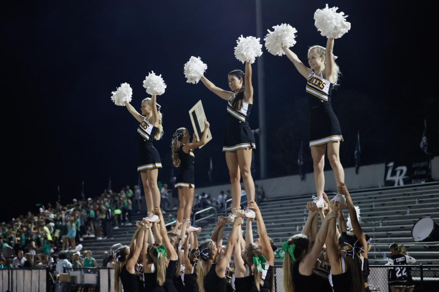 The+varsity+cheerleading+team+performs+at+the+varsity+football+game+at+Lafayette+against+Hazelwood+West+on+Sept.+24%2C+2021.+For+every+football+game%2C+the+varsity+team+performs+a+series+of+stunts+while+the+football+team+kicks+off+the+beginning+of+the+game.