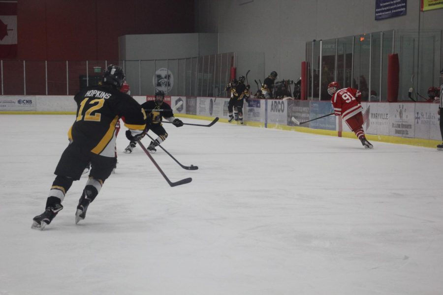 Junior Christian Hopkins searches for the puck during the Lancers game against Kirkwood. The Lancers fell to Kirkwood and were relegated from the Challenge Cup to the Wickenheiser Cup