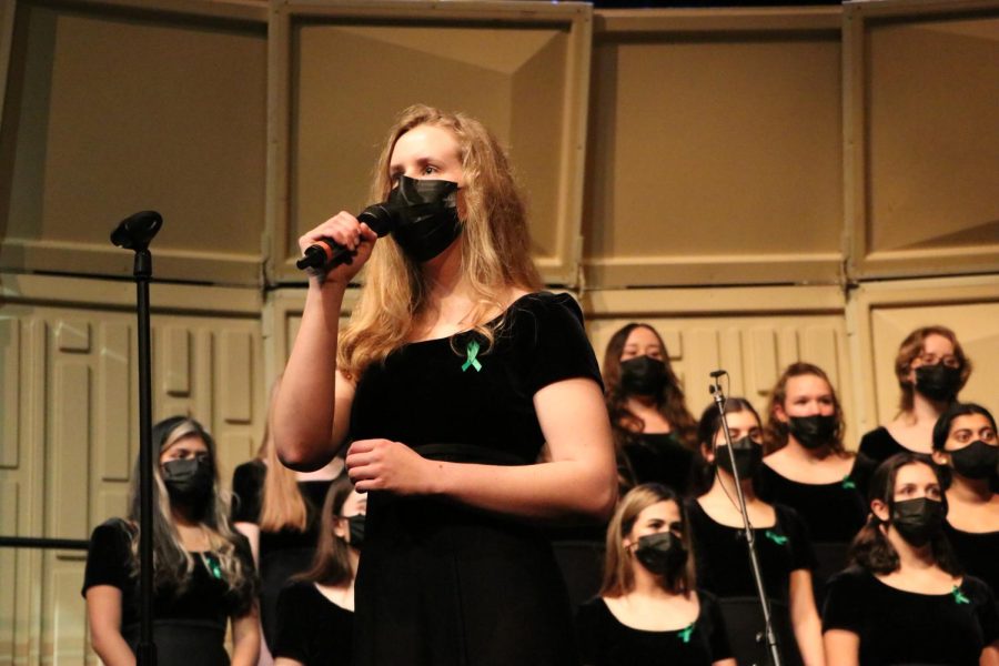 While at the Winter Choir Concert on Dec. 15, 2021, senior Audrey Hoeft performs a solo. Adding to the choir classes next year will be the new show choir: Mic Drop. The class will involve singing and dancing, and feature a variety of songs from various genres and styles.