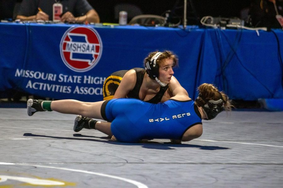 Senior Faith Cole wrestles during a match in the 2021 MSHSAA girls wrestling State Championships, where she won a third straight State Championship. In the 2022 MSHSAA girls wrestling State Championships, Cole won a record-setting fourth straight State championship. Overall, the varsity girls wrestling team has gained a top ten result at each State Championship since the 2018-19 season. 