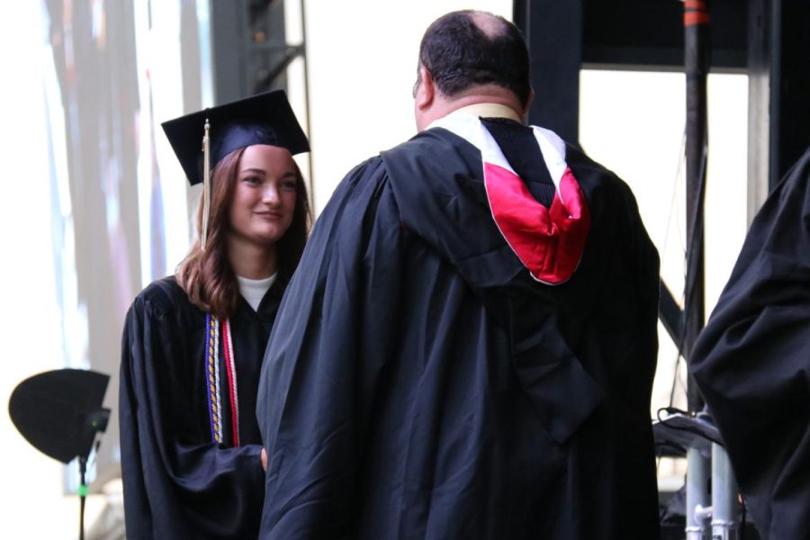 At the Class of 2021 Graduation, Rachel Brown receives her diploma from Rockwood Board of Education Director Thomas Dunn, Brown earned honor cords for journalism, social studies, language arts,   fine arts and Quill and Scroll.