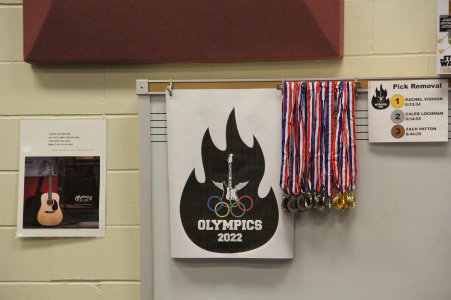 The poster for Guitar Olympics hangs over the whiteboard in the guitar teacher Traci Bolton's classroom. Although this was the first year of the event, Bolton said the idea started last year. 