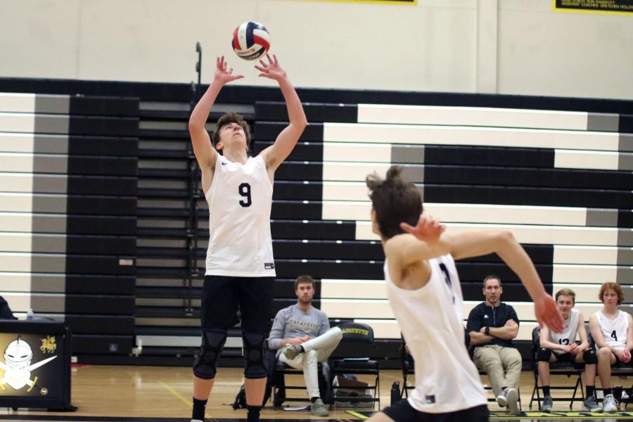 Sophomore Kyle Kubasta attempts to hit the ball over the net during the Lancers game against Fox. Kubasta would have six aces and seven attack attempts as the Lancers swept Fox in three sets.  