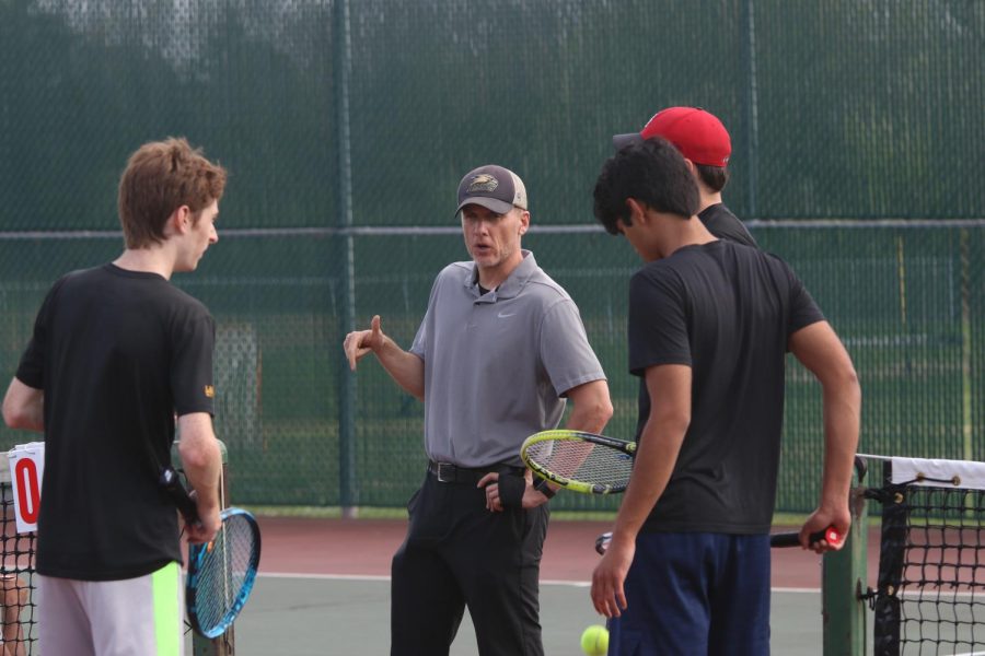 Varsity+boys+tennis+head+coach+Mark+McAllister+speaks+to+team+members+during+the+Lancers+match+against+Ladue.+The+Lancers+have+a+6-16+overall+record+against+Ladue+after+their+match+on+April+12.+