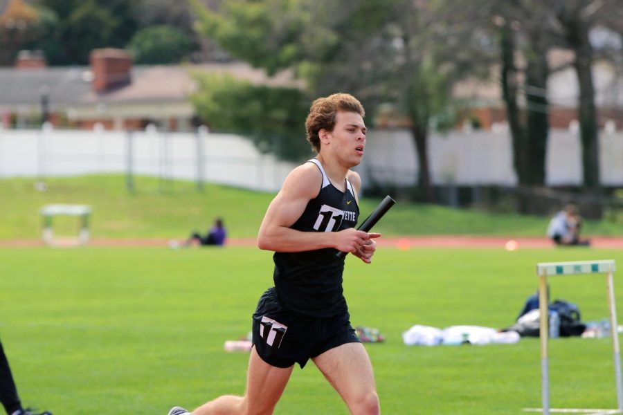 Senior Nikolas Malek participates in a relay. The Lancers were largely successful during the relays of the Northwest Invitational, taking a top ten spot in all relay events. 