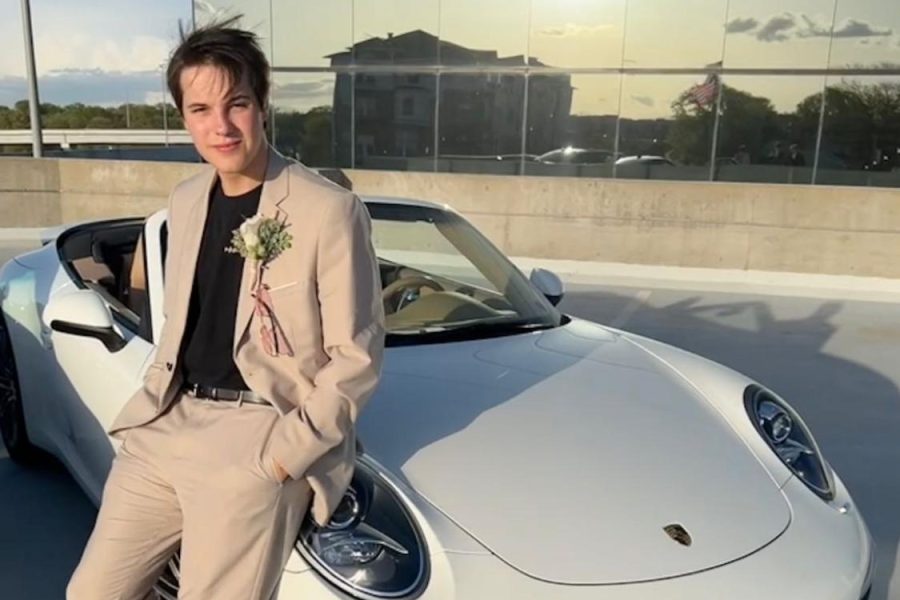 Posing with a car he detailed, senior Vince Deutchmann borrowed the car for prom as a payment for detailing it.