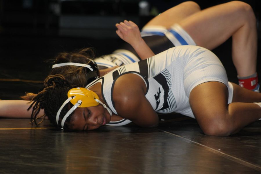 Senior Seraphina Blackmon works to pin her opponent on girls wrestlings senior night. Blackmon started wrestling to spite her middle school principal. “At first I was doing it to spite him, but I enjoyed it afterwards. After [freshman year], I got better and I enjoyed being around everyone, Blackmon said.