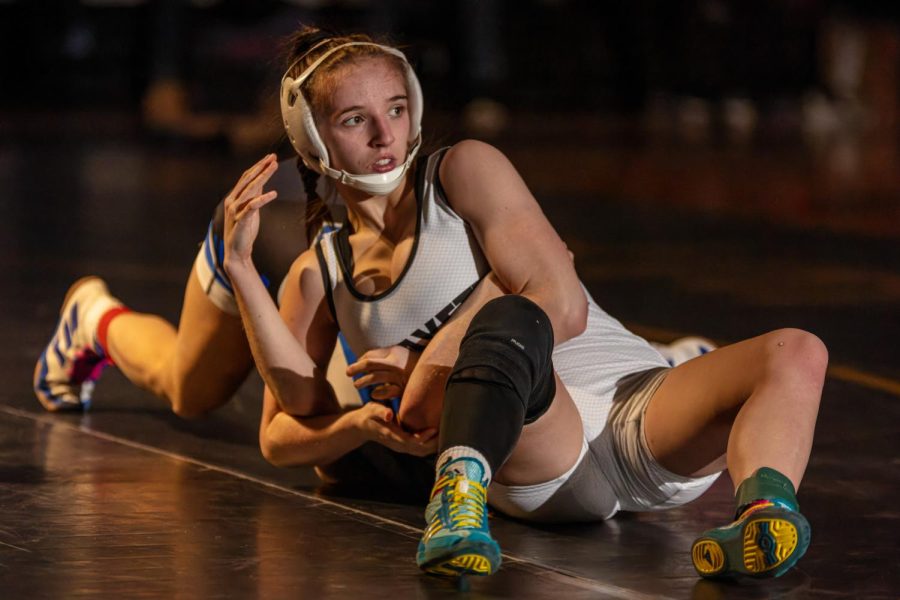 Senior Faith Cole pins her opponent in a wrestling match. Cole has been the State champion for all four years of her high school career.