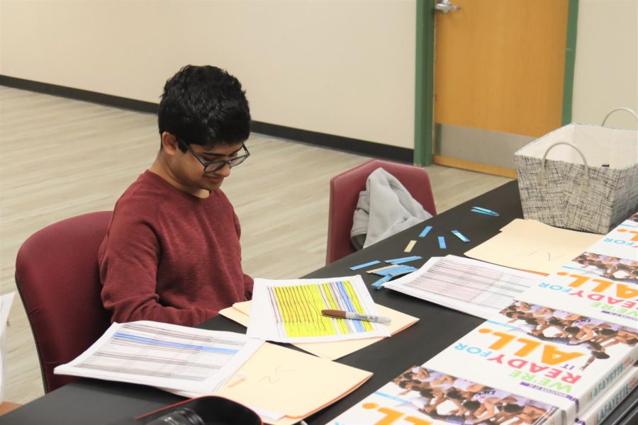 Yearbook staff member Jude Thomas helps distribute the 2022 Legend. Yearbooks are typically finished at the end of a school year and are given to students around the beginning of the following school year.
