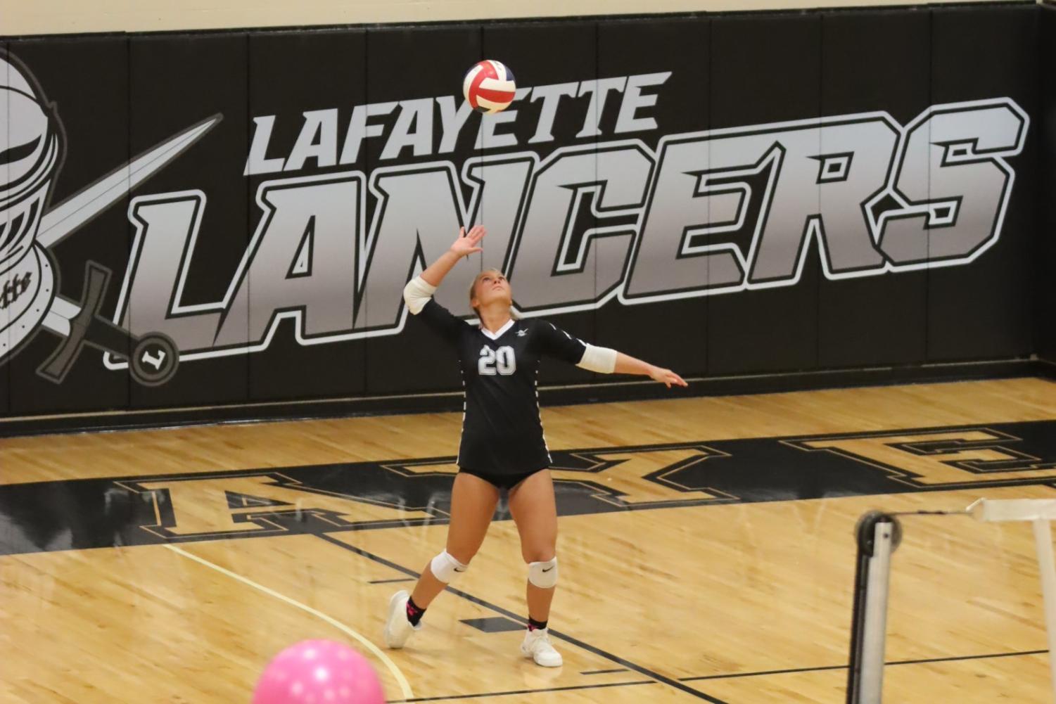 During the game on Sept. 16, senior Audrey Savacool spikes the ball to the other side during a volley. The game was the Chris Toomey memorial game, which was played in honor of the former coach who passed away over the summer. 