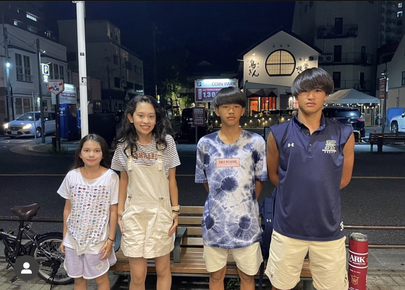 Freshman Akiko Field poses for a picture with her cousins in front of a restaurant in Japan.