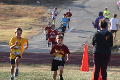 Elementary School Students run down the final stretch of the Rockwood middle and elementary school track meet.