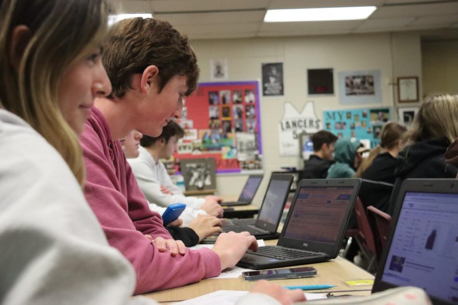 During Economics and Personal Finance, juniors Hudson Kohler and Ella Manning research stocks as part of a stock market simulation project. For the project, they had to follow a $10,000 budget while teacher Vince DeBlasi gave them advice on what types of stocks to invest in to achieve the highest possible capital gains. The class is designed to help students learn saving and investing strategies and meets the .5 personal finance credit necessary to graduate through the required Missouri Personal Finance Assessment taken during the course.