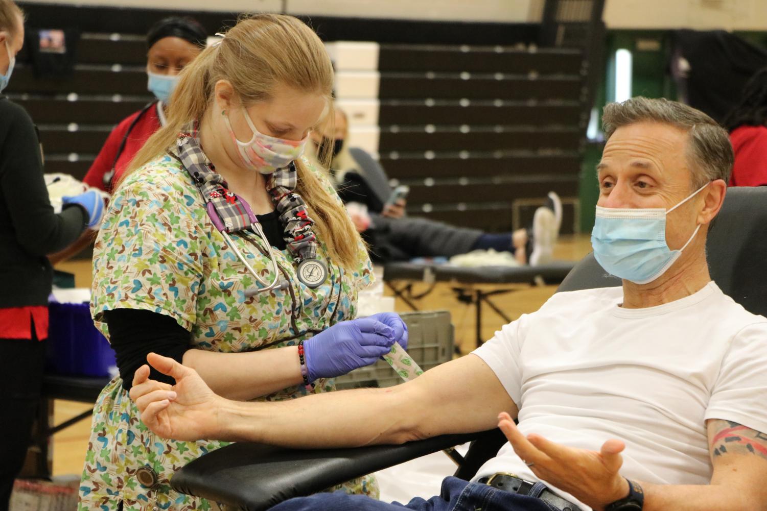 At the 2022 blood drive on Jan. 28, social studies teacher Vincent Deblasi donates blood.  This year, the drive will be on Jan. 27 from 8 a.m. to 1 p.m.