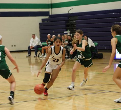 While facing Marquette Dec. 2, senior Shru Singh dribbles the ball away from the opposing team. Singh helped the girls basketball team get their first win Jan. 12, scoring 21 points against Parkway Central.