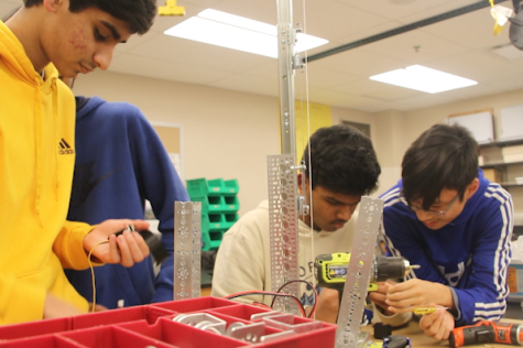 Robotics team members freshmen Ahan Singh, Pardhu Konakandla and Giancarlo Fernandez put together a robot. The Hadrons worked together to prepare for the competition.