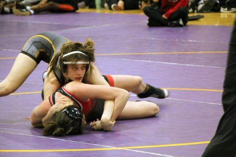 Junior Toby Goertz pins down her opponent at the Fred Ross Invitational. At the invitational, Goertz placed second while her team placed fifth overall.