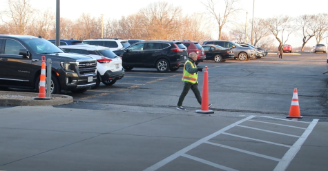 Before the student traffic arrives, parking lot attendant Barb Mullen arrives shortly after 7 a.m. and sets the cones out to block off the lanes in the first two rows. Mullen has been working at LHS for 14 years.
