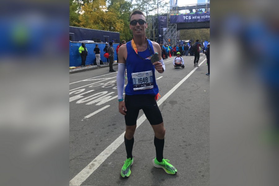 Math teacher Steven Stallis poses at the finish line of the New York marathon. Stallis ran this marathon twice and prefers the second race due to better weather and a better time.