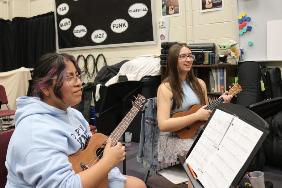 Students Ella Nolan and Lexi Balog practice their ukuleles at the weekly practice.