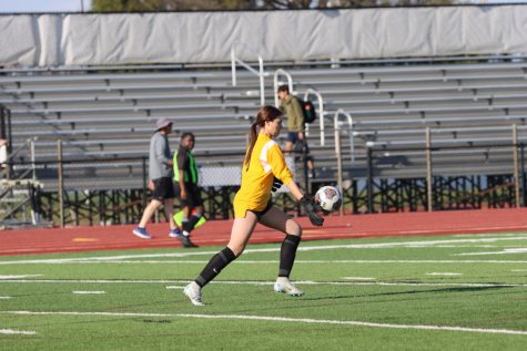 Dropping the ball in front of her feet, freshman Gen Newell prepares to volley the ball. Newell has achieved four clean sheets this season.