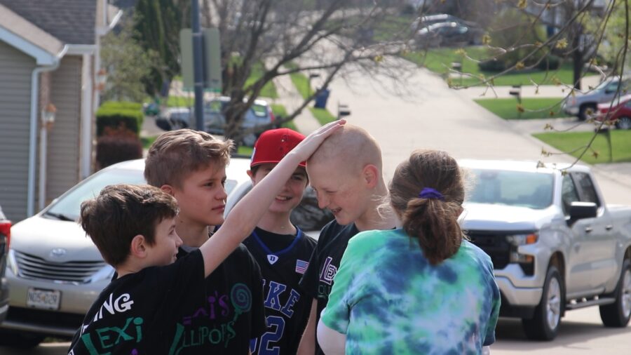 On April 7, 2023, Conner Bunchs friends feel his shaved head during the event. Conner first started shaving his head in 2016.