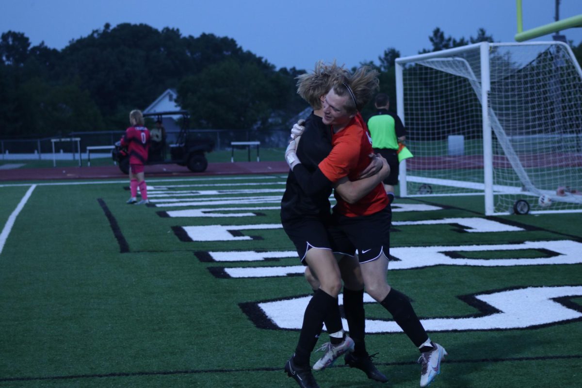 Embracing each other, seniors Daxton Shawke and goalkeeper Jack Burkhardt celebrate their win against Timberland. In the win, the Lancers had to go to penalty kicks to settle the score, 