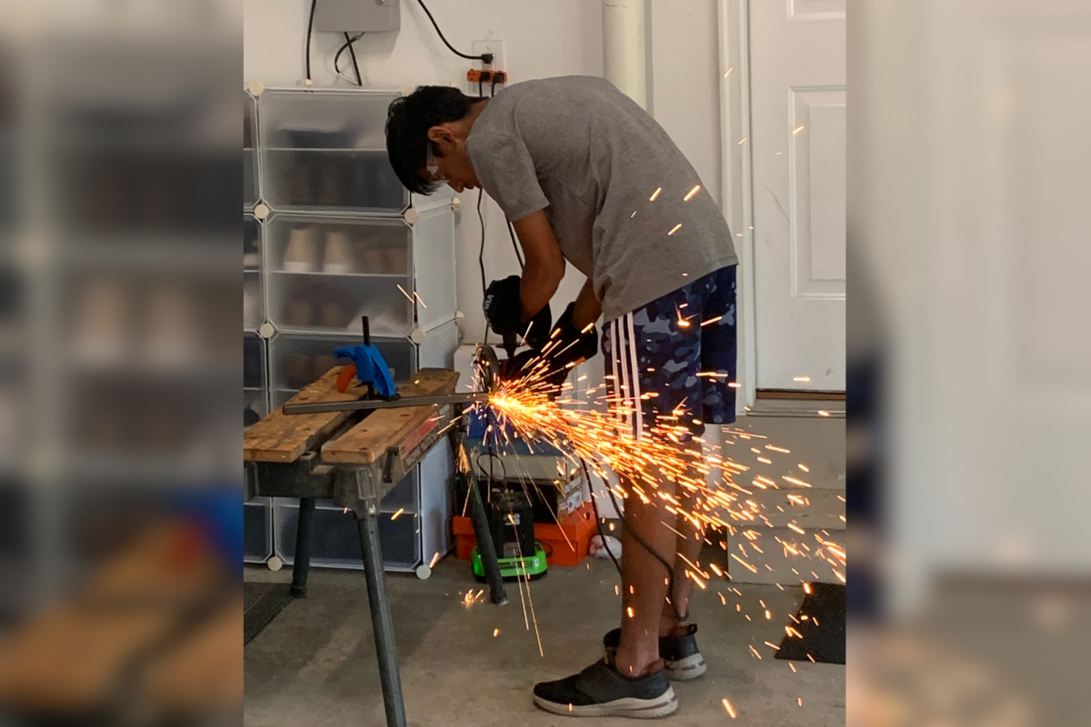 To build the frame for the Car Club’s go-kart, sophomore Adit Swami cuts metal in his garage. Working with sophomore Logan Martin’s dad, Matt Martin, Swami learns more about metal working and takes back to teach the other members of the club.